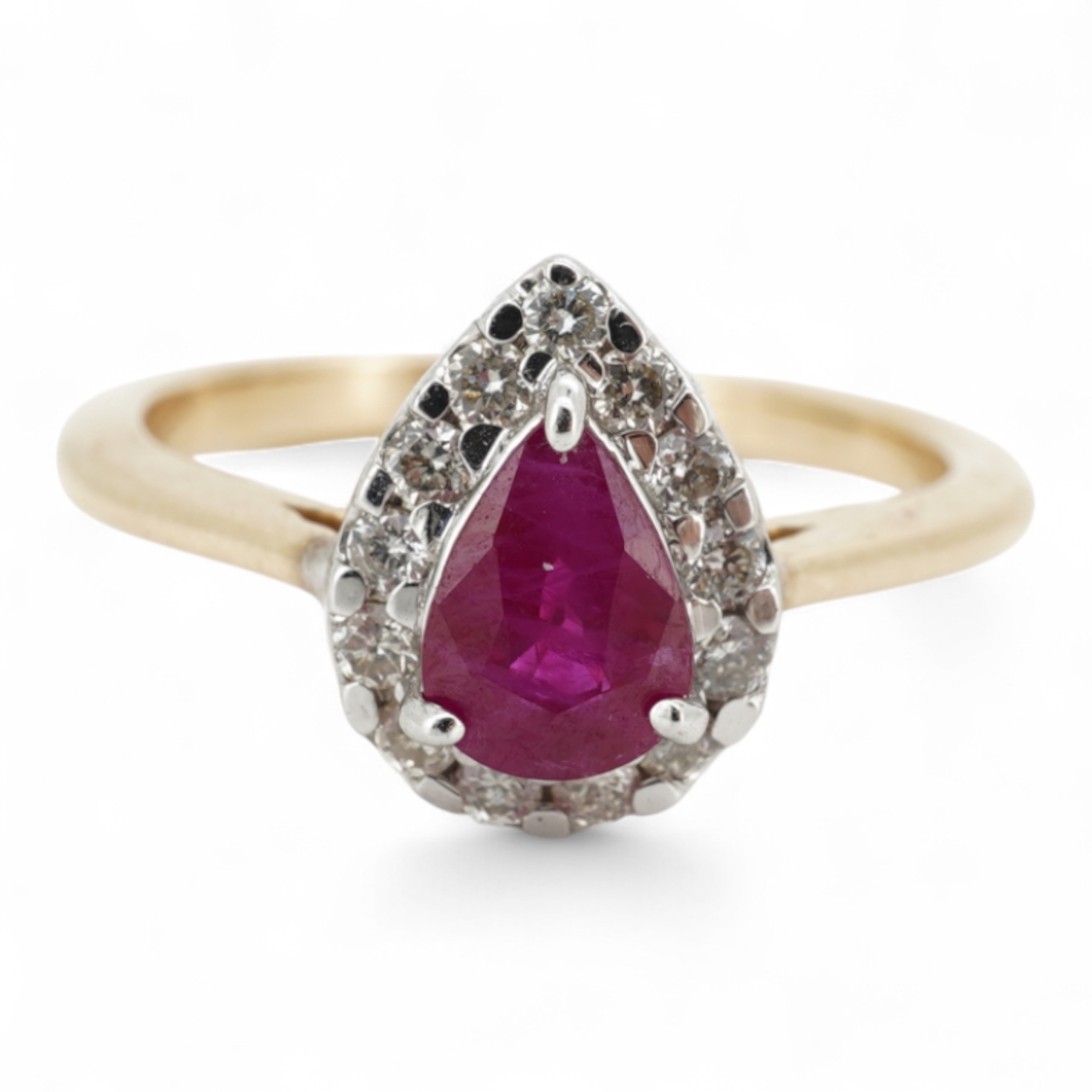 A ruby and diamond cluster ring, claw-set with a pear-shaped ruby weighing approximately 0.60 carats, within a border of brilliant-cut diamonds totalling approximately 0.42 carats, mounted in 14ct gold, size N, British h